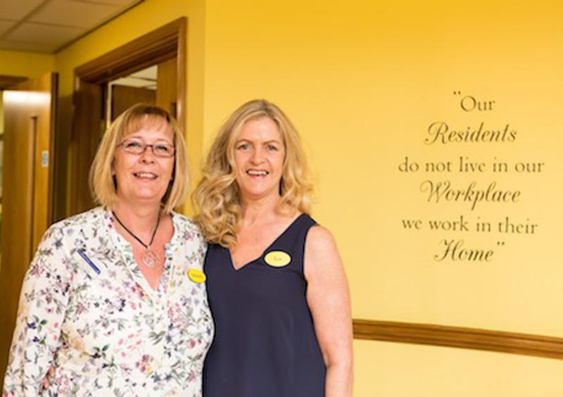 Two female members of staff at John Wills House care home in Bristol