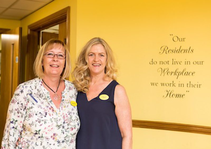 Two female members of staff at John Wills House care home in Bristol